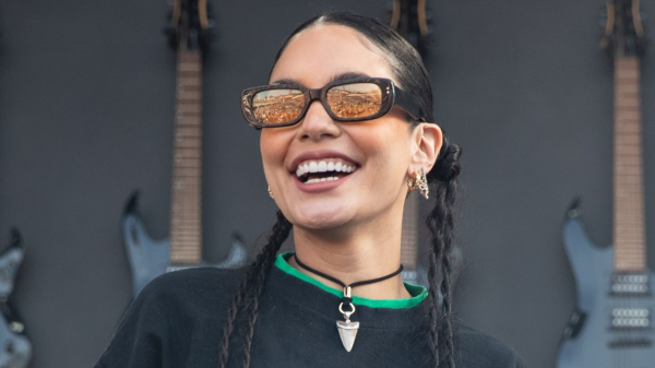 Vanessa Hudgens smiling and wearing braids and glasses