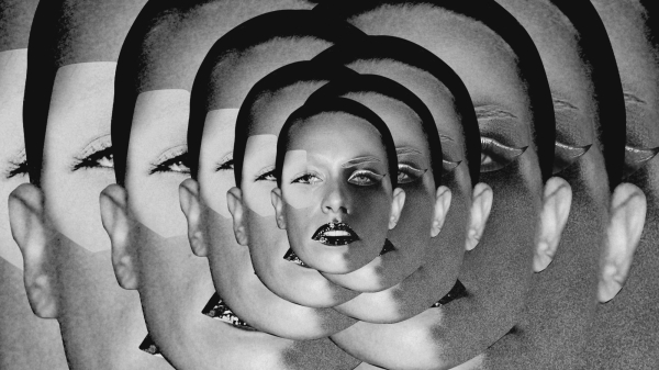 The same image of blackandwhite image of a woman's face layered on top of one another to create a kaleidescopelike effect.